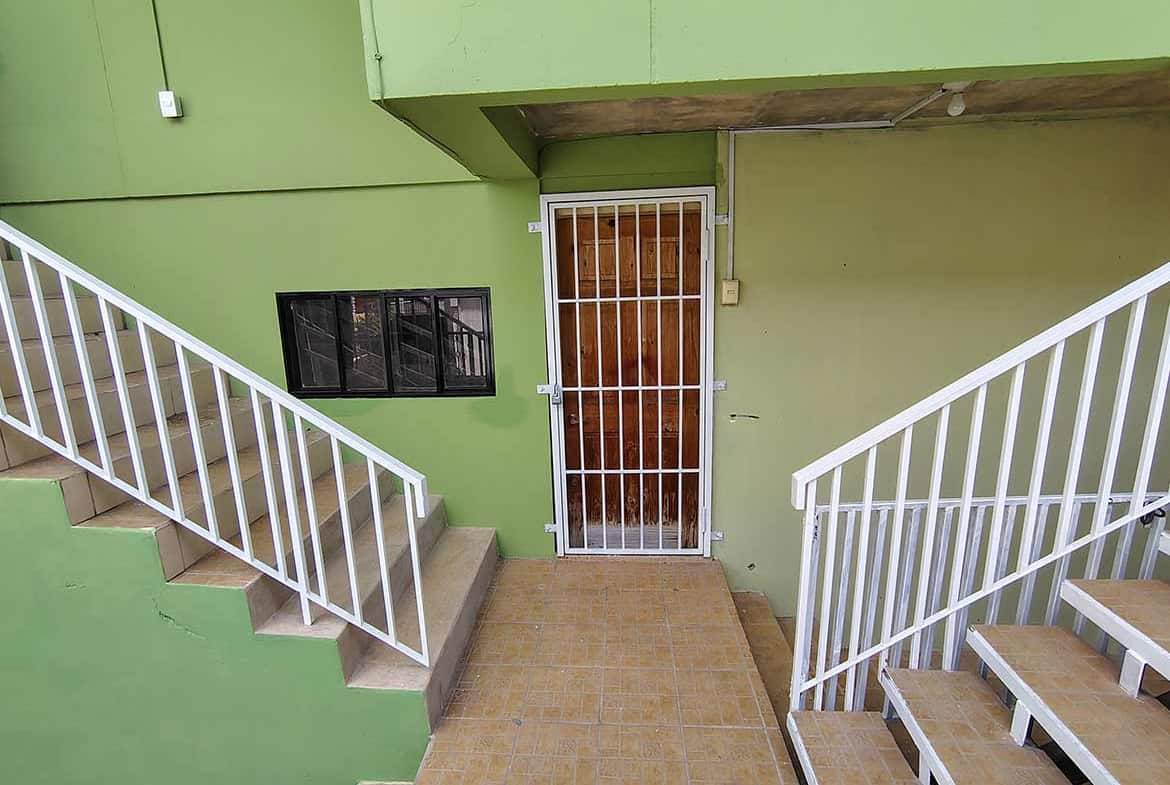 Cornerstone- Entrance to Ganga Terrace with green walls and staircases.