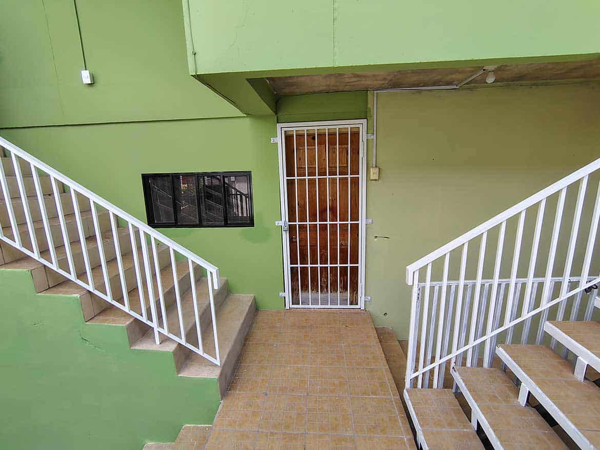 Ganga Terrace Entrance Cornerstone- Entrance to Ganga Terrace with green walls and staircases.