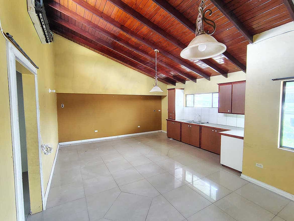Spacious Kitchen at Ganga Terrace Cornerstone- Bright, open kitchen with wooden ceiling and modern fixtures at Ganga Terrace.