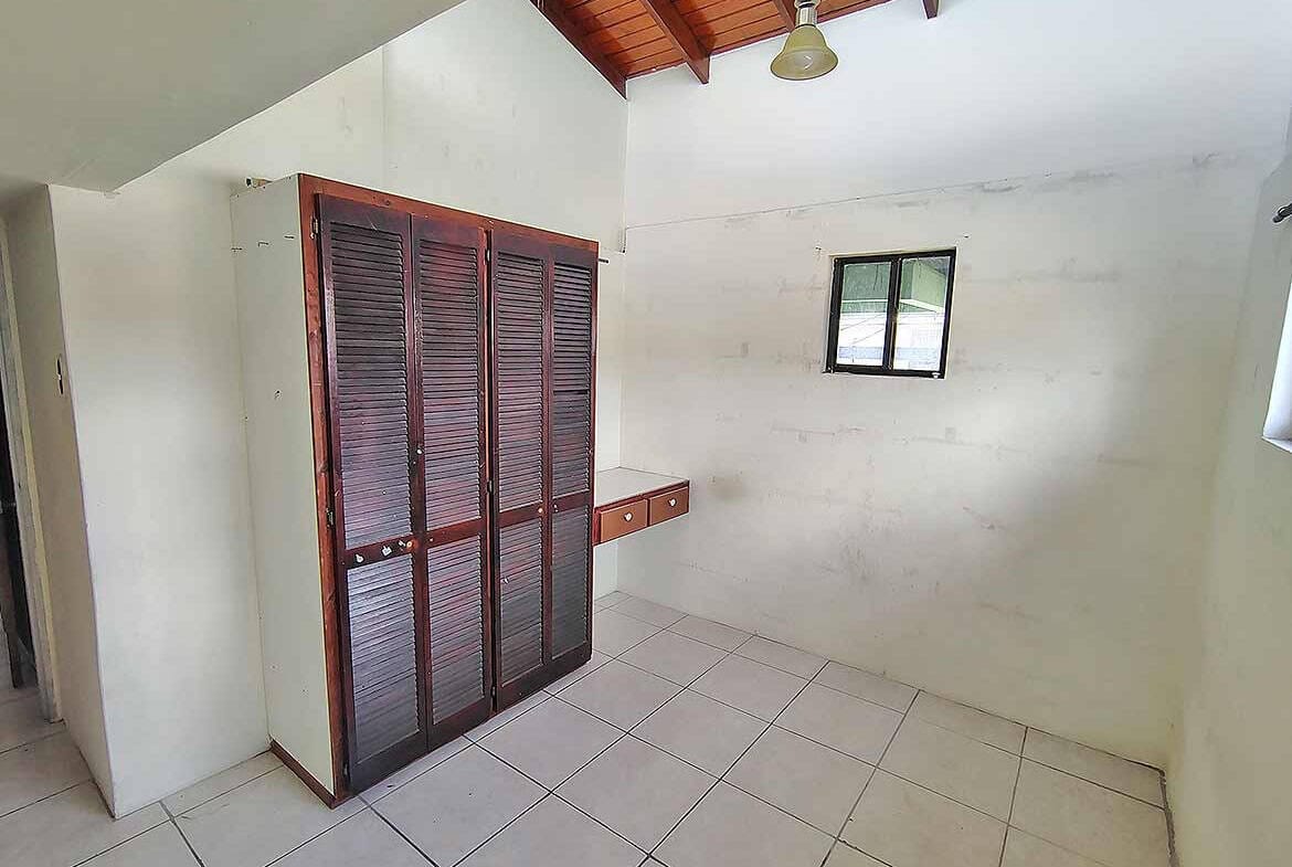 Cornerstone- Empty room with wooden closet and small window in Ganga Terrace.