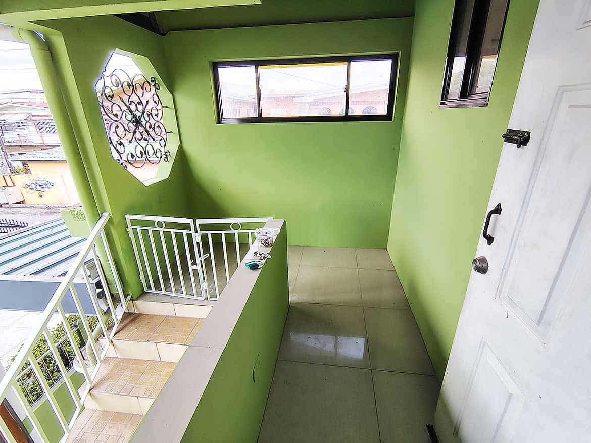 Ganga Terrace Balcony View Cornerstone- Bright green balcony with white railing and large window in El Socorro.