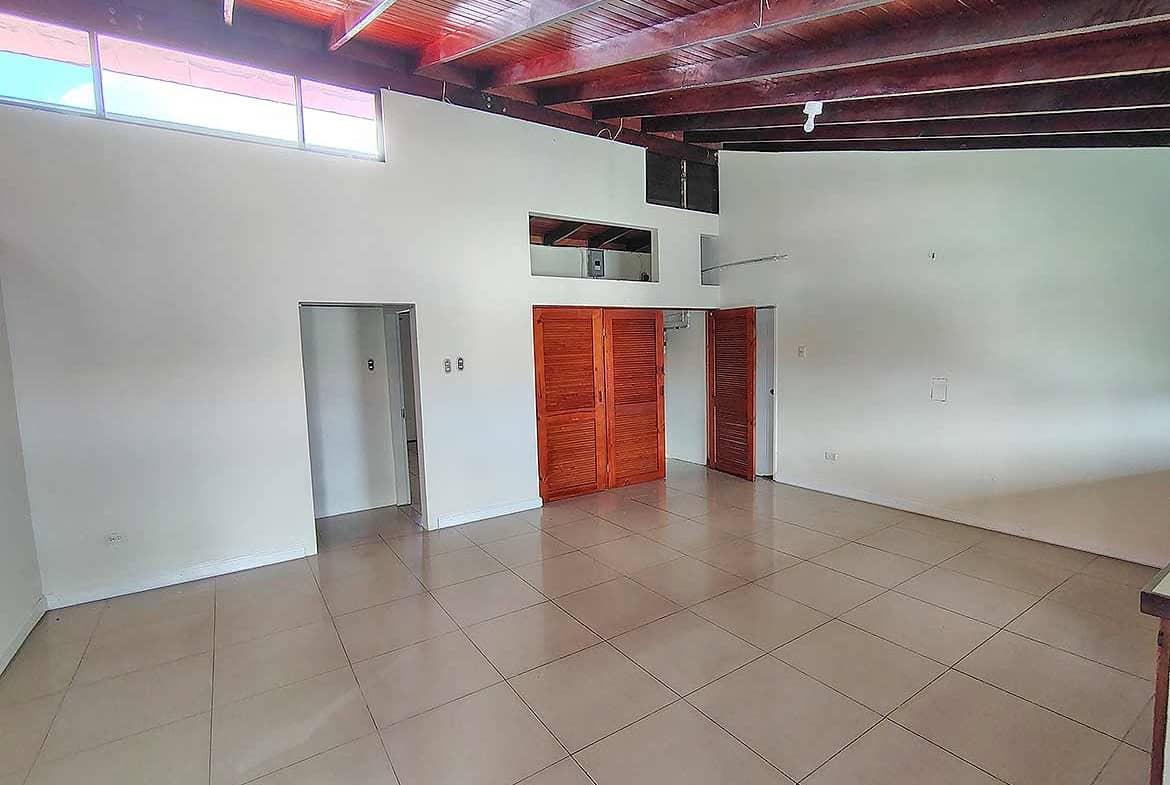 Cornerstone- Interior view of Ganga Terrace with high ceilings and wooden accents.
