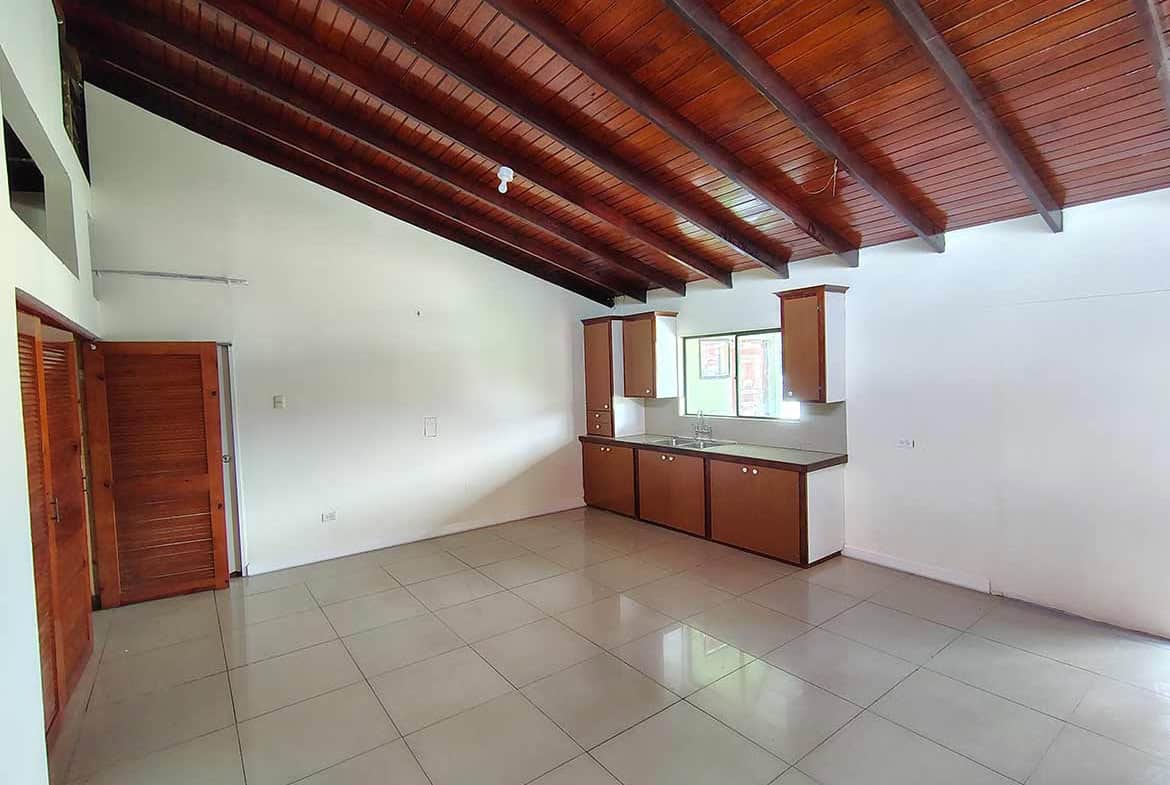 Cornerstone- Bright, open living space with wooden ceiling and tiled floor at Ganga Terrace.