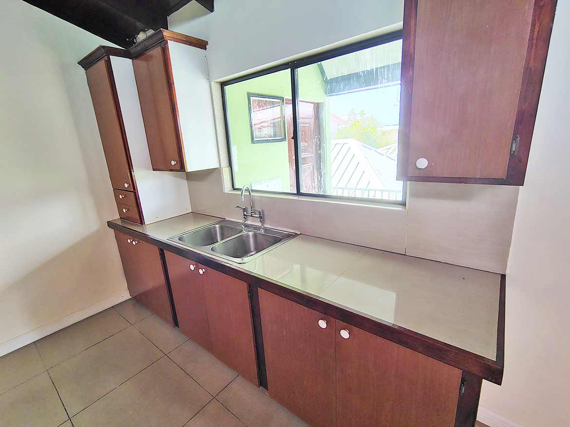 Cornerstone™ Kitchen in Ganga Terrace Cornerstone- Modern kitchen with wooden cabinets and stainless steel sink in Ganga Terrace.