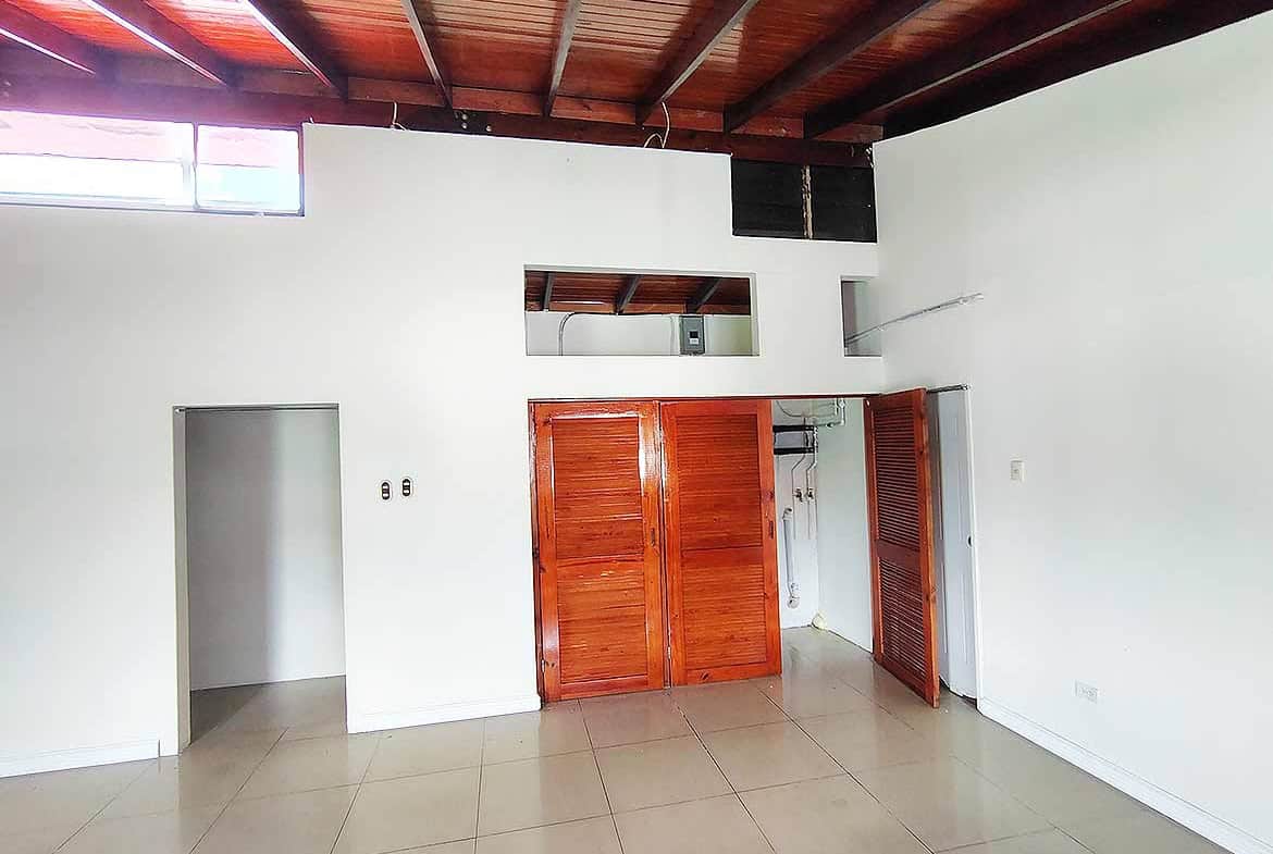 Cornerstone- Spacious room with wooden ceiling and built-in closet at Ganga Terrace.