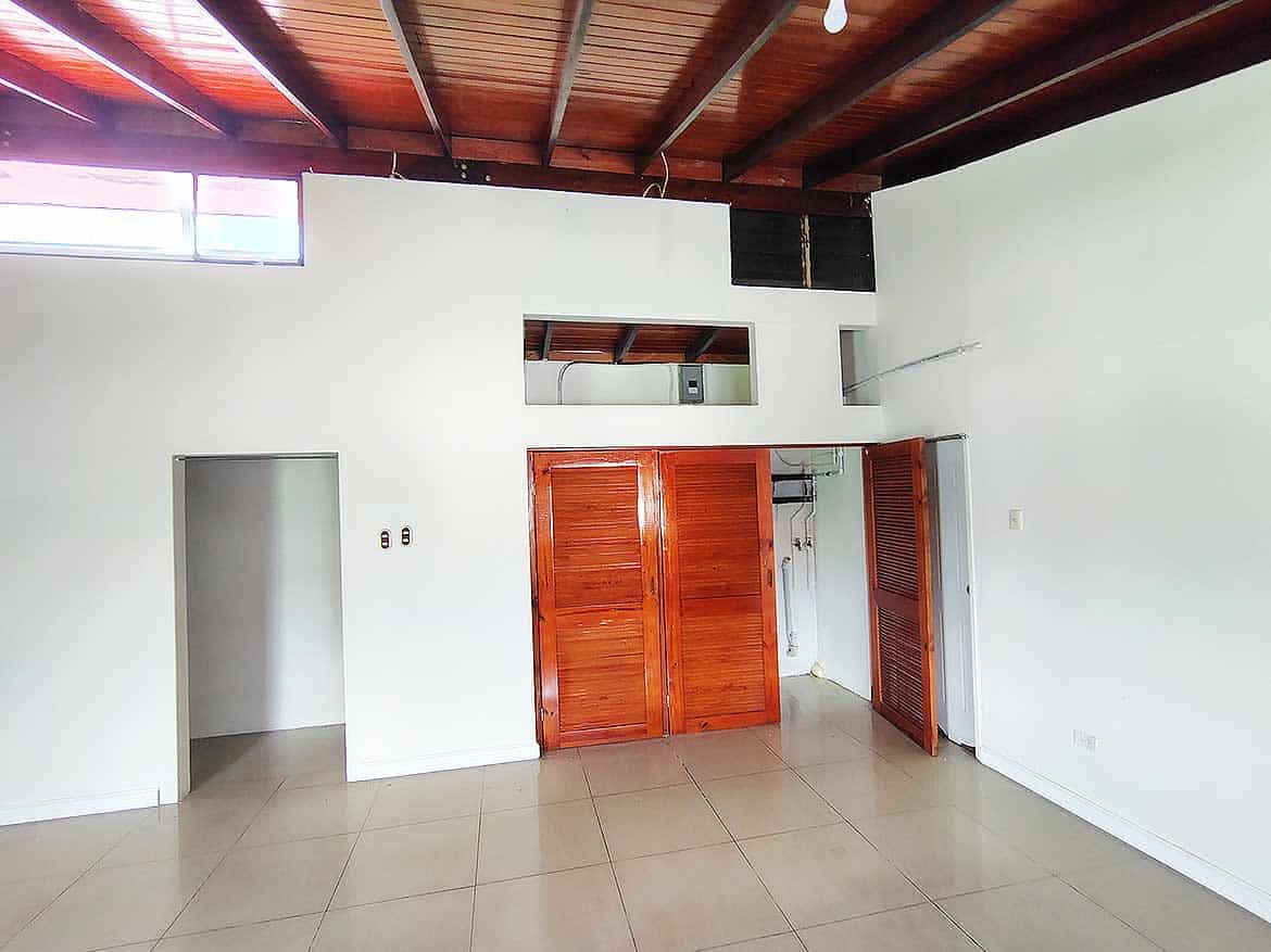 Modern Interior of Ganga Terrace Cornerstone- Spacious room with wooden ceiling and built-in closet at Ganga Terrace.