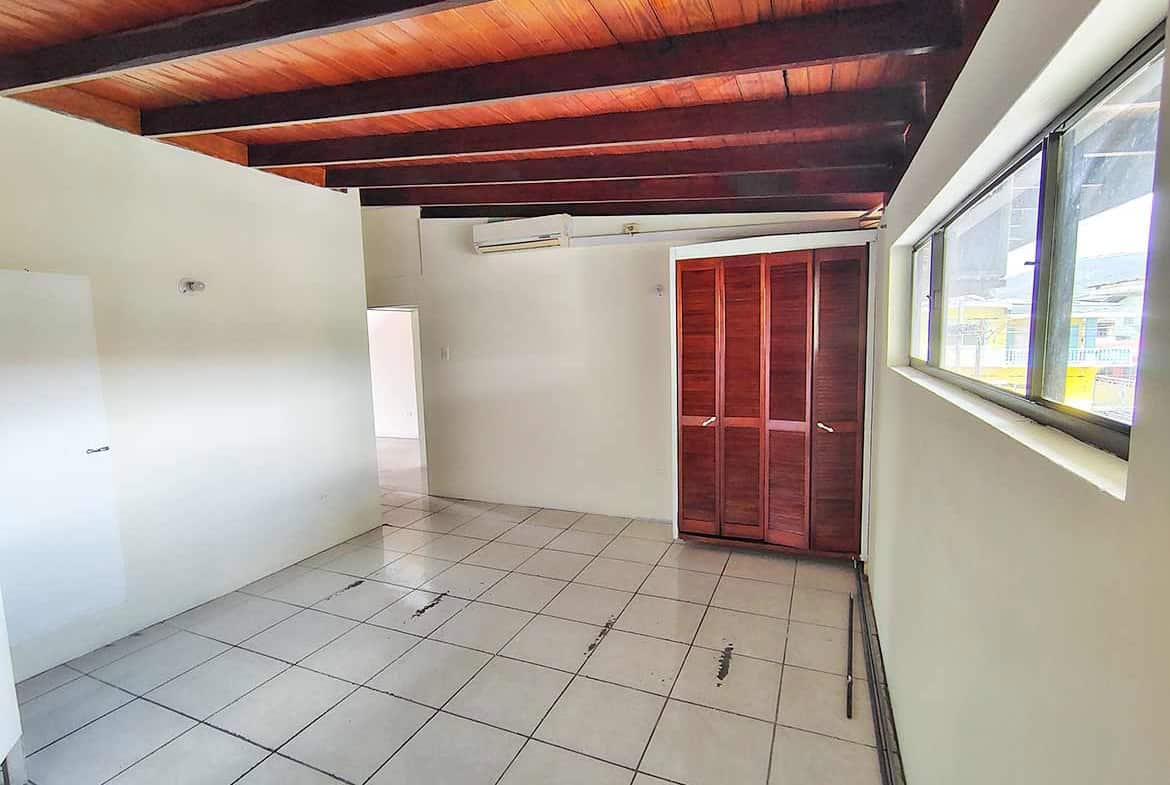 Cornerstone- Spacious room with tiled floor, wooden ceiling, and large window at Ganga Terrace.