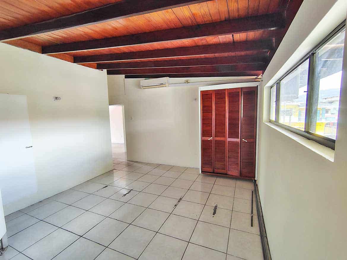 Interior of Ganga Terrace, El Socorro Cornerstone- Spacious room with tiled floor, wooden ceiling, and large window at Ganga Terrace.