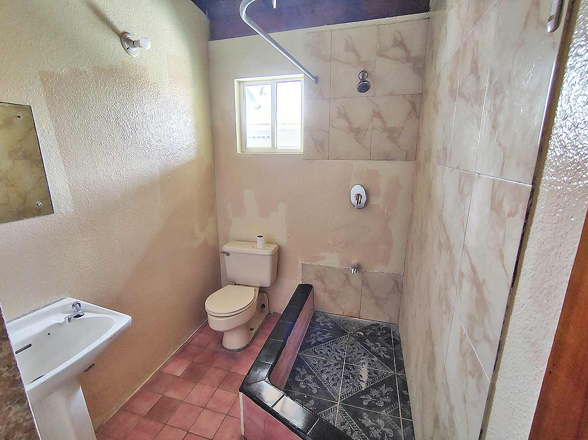 Bathroom at Ganga Terrace, El Socorro Cornerstone- Bathroom with toilet, sink, and shower area at Ganga Terrace.