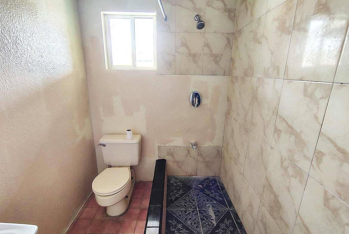 Cornerstone- Modern bathroom with toilet and shower area in Ganga Terrace, El Socorro.