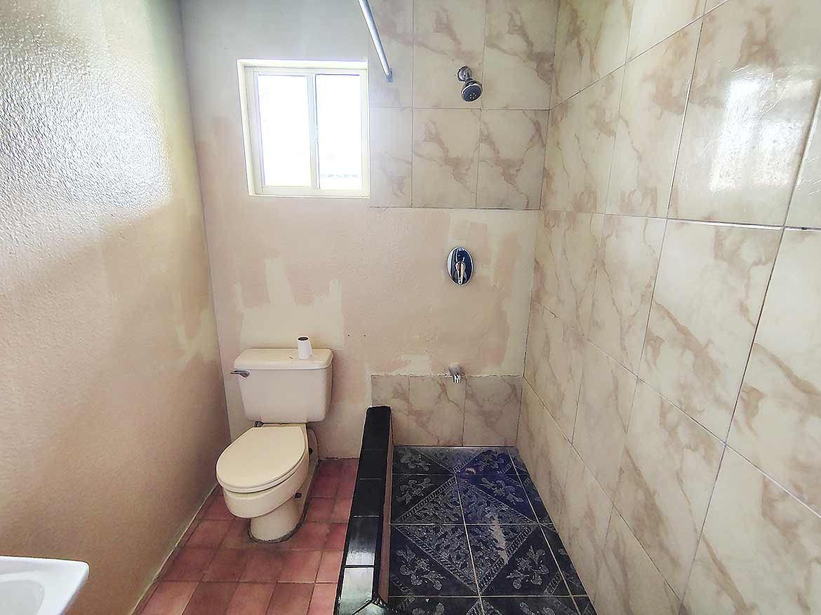 Bathroom Renovation at Ganga Terrace Cornerstone- Modern bathroom with toilet and shower area in Ganga Terrace, El Socorro.