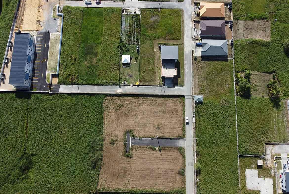 Cornerstone- Aerial view of residential plots and houses in Longdenville, Trinidad.