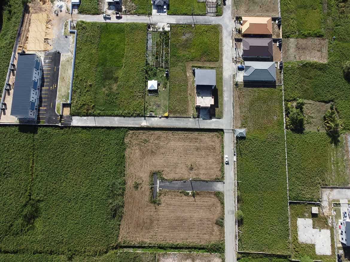 Cornerstone- Aerial view of residential plots and houses in Longdenville, Trinidad.