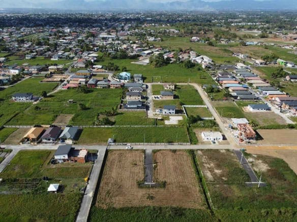 Cornerstone- Aerial view of Longdenville residential neighborhood with houses and open fields.