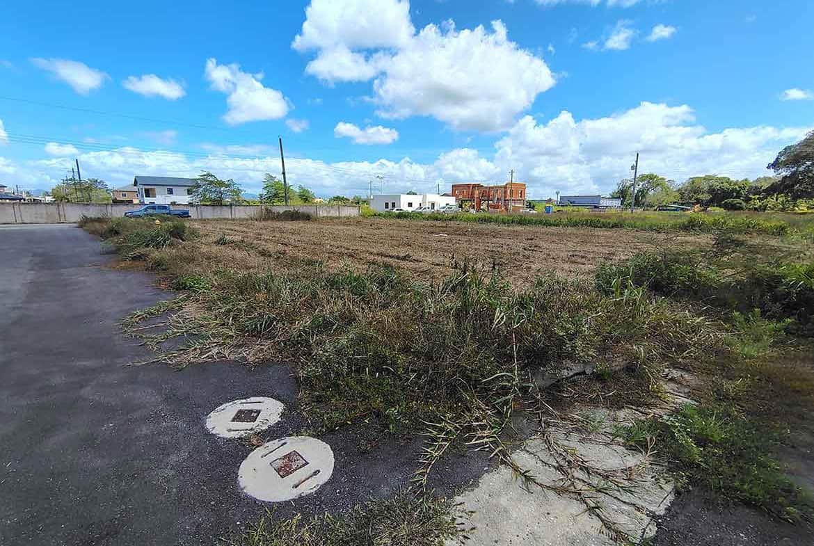 Cornerstone- Open vacant land on St Louis Dr, Longdenville with blue sky and clouds.