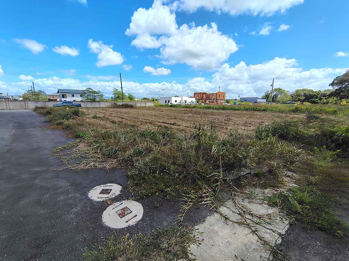 Cornerstone- Open vacant land on St Louis Dr, Longdenville with blue sky and clouds.