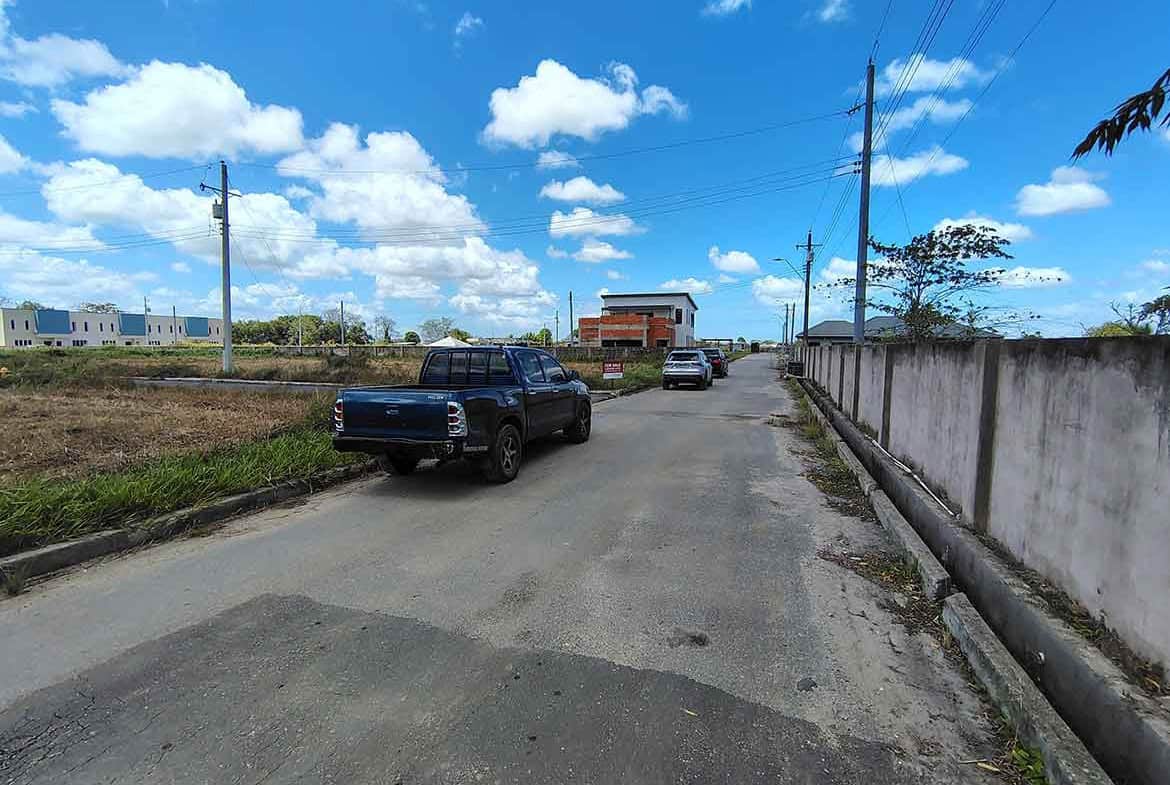 Cornerstone- Residential street on St Louis Dr, Longdenville with parked cars and clear sky.