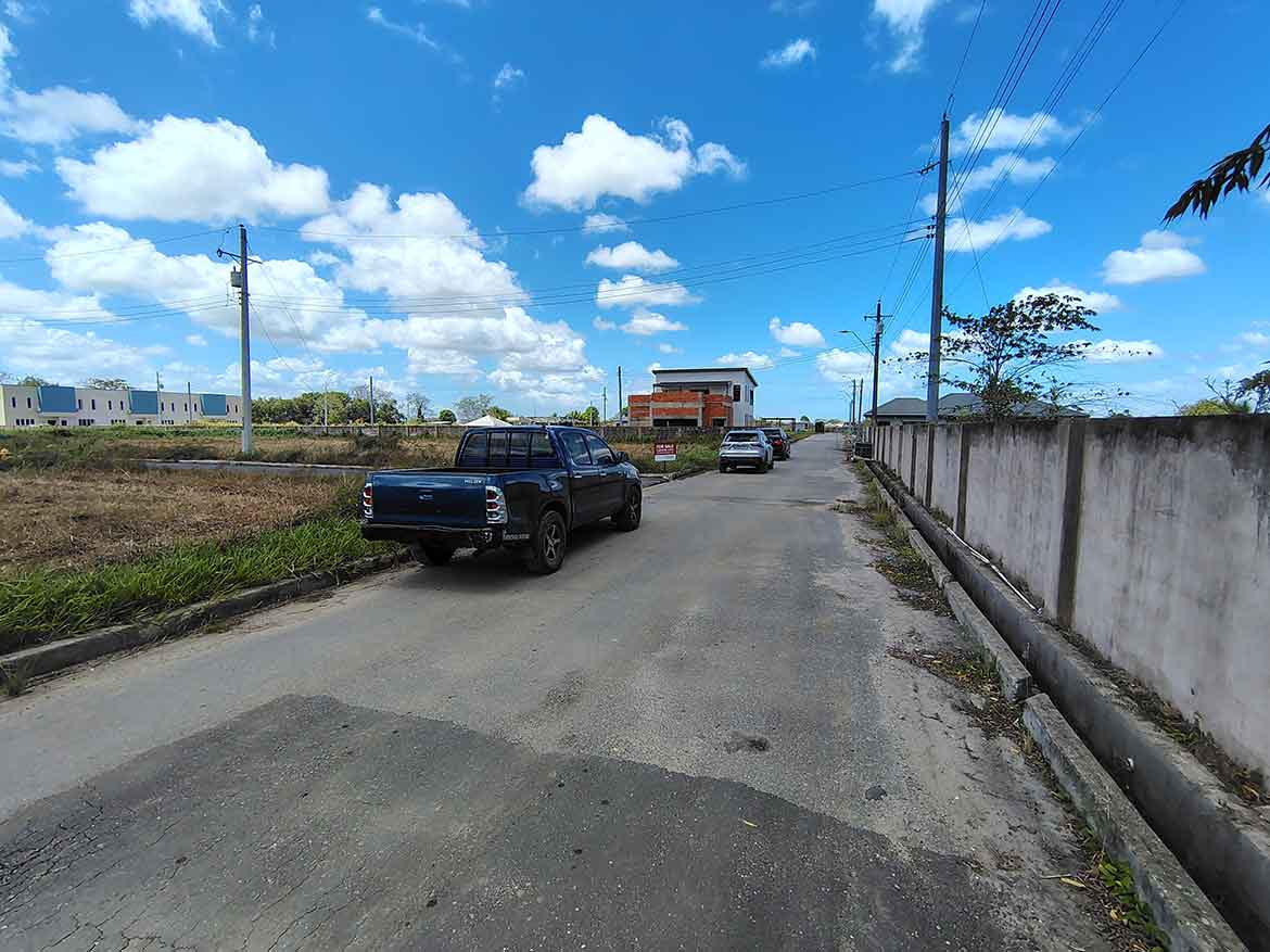 Cornerstone- Residential street on St Louis Dr, Longdenville with parked cars and clear sky.