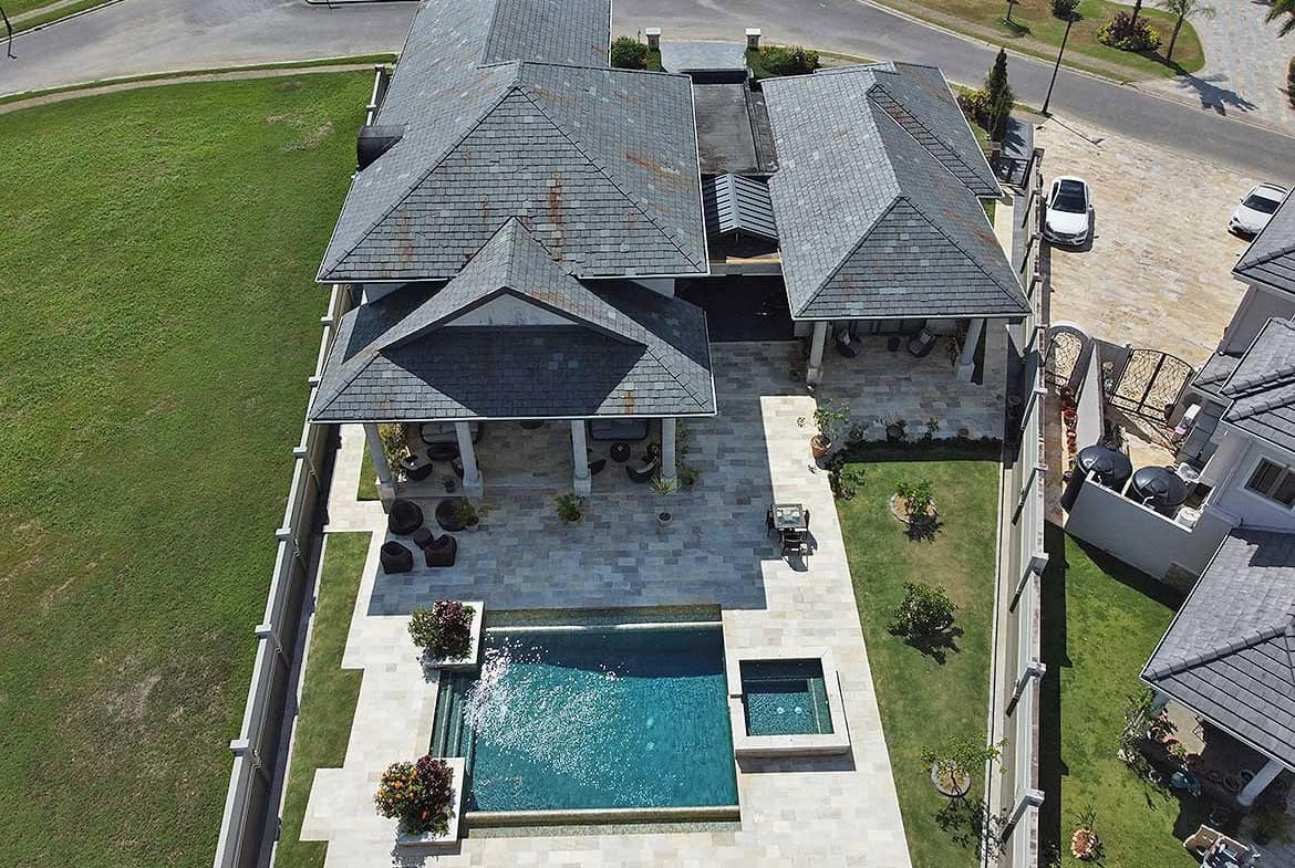 Cornerstone- Aerial view of Millennium Lakes home with pool and landscaped yard.