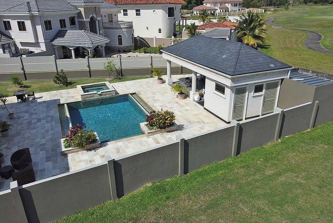 Cornerstone- Modern backyard with pool, patio, and garden at Millennium Lakes Home.
