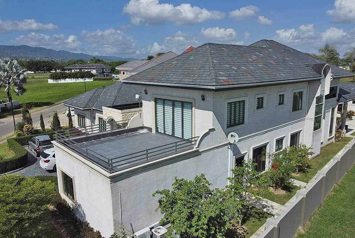 Cornerstone- Elegant two-story house with a gray roof and white exterior near Millennium Lakes.