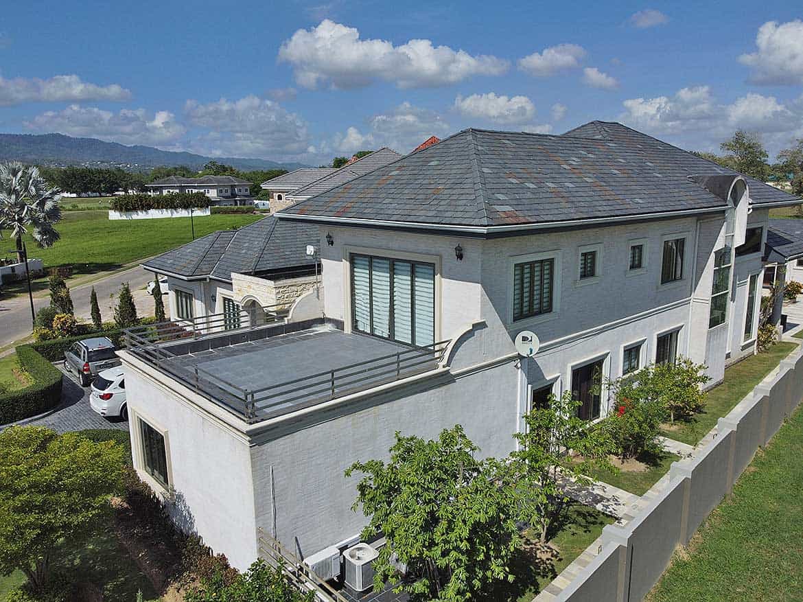 Luxury Home at Millennium Lakes Cornerstone- Elegant two-story house with a gray roof and white exterior near Millennium Lakes.