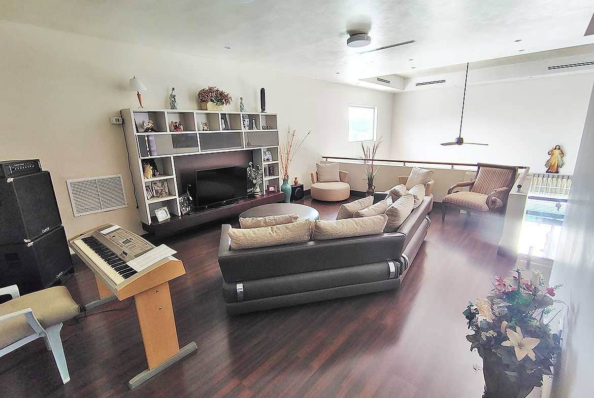 Cornerstone- Bright, modern living room with comfortable seating and entertainment center.