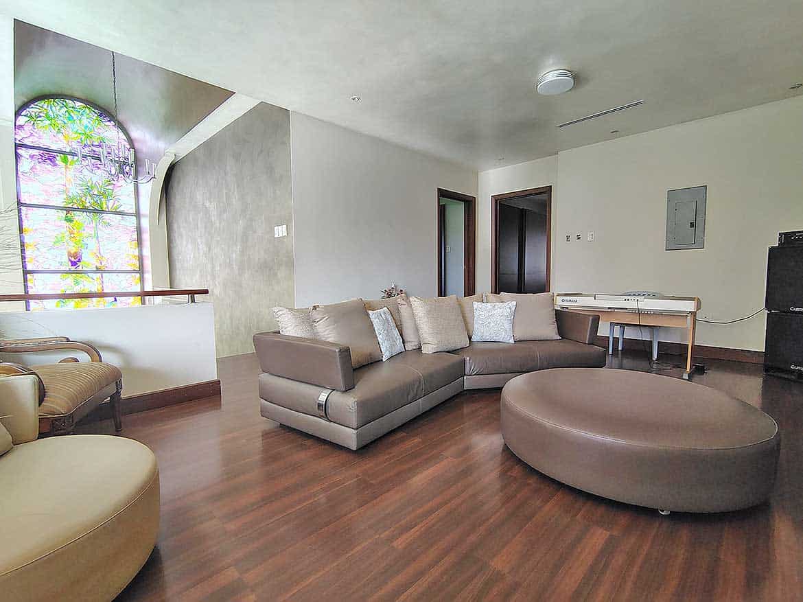 Modern Living Room at Millennium Lakes Cornerstone- Spacious living room with large sectional sofa and wooden flooring.
