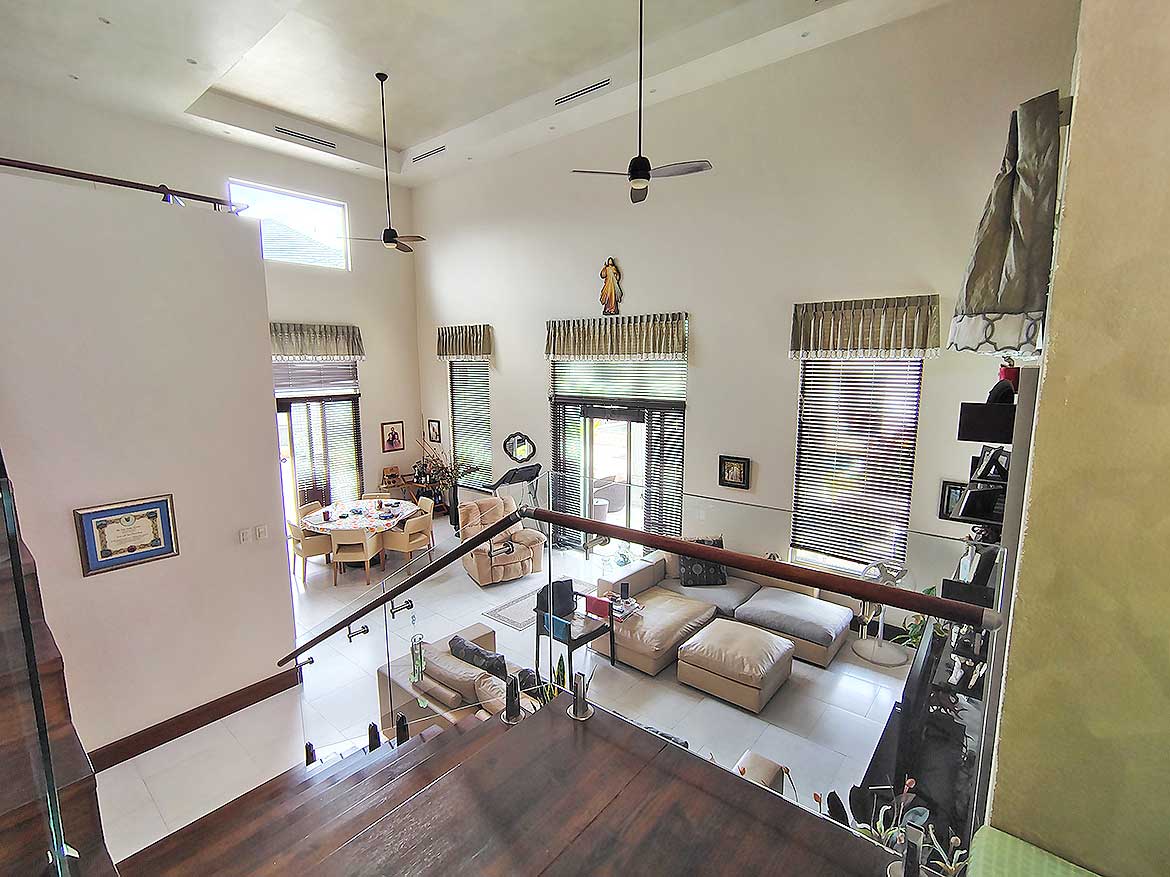 Spacious Living Room at Millennium Lakes Home Cornerstone- Bright, modern living room with high ceilings and large windows.