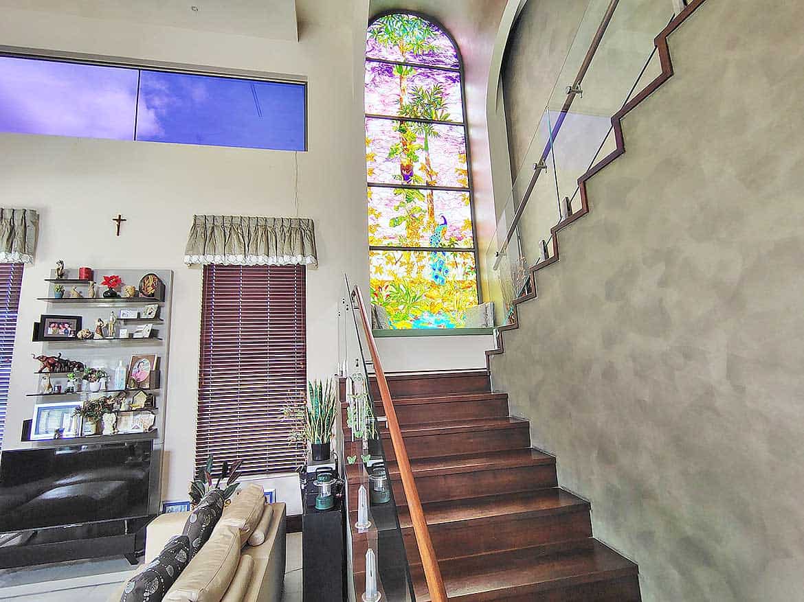Millennium Lakes Home Interior Staircase Cornerstone- Interior staircase with large stained glass window and modern decor.