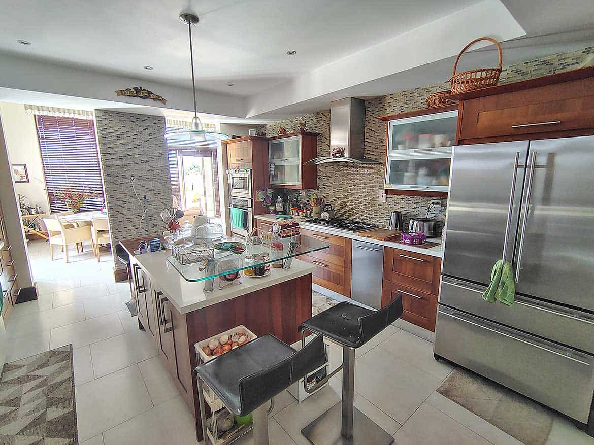 Modern Kitchen at Millennium Lakes Home Cornerstone- Spacious modern kitchen with stainless steel appliances and island.