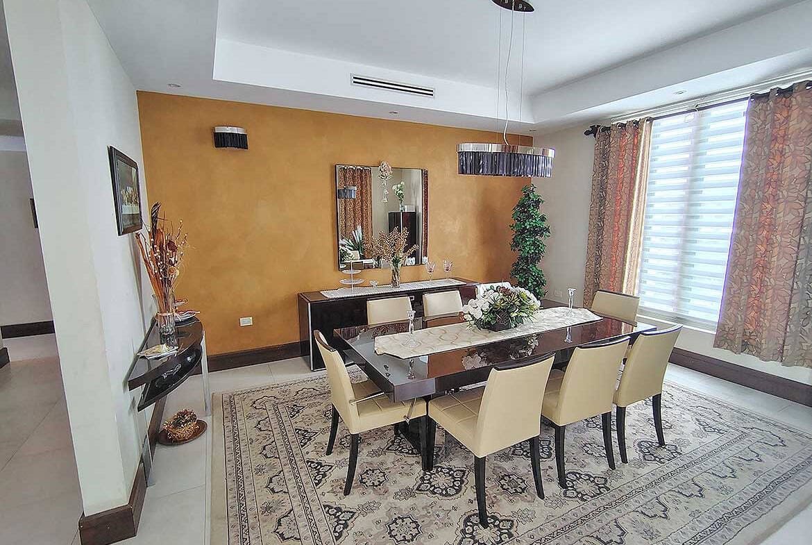 Cornerstone- Spacious dining room with modern decor and large windows at Millennium Lakes Home.