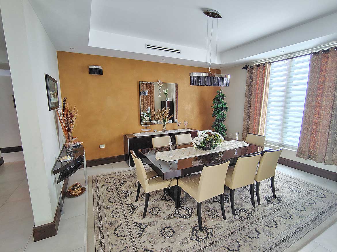 Elegant Dining Room at Millennium Lakes Home Cornerstone- Spacious dining room with modern decor and large windows at Millennium Lakes Home.