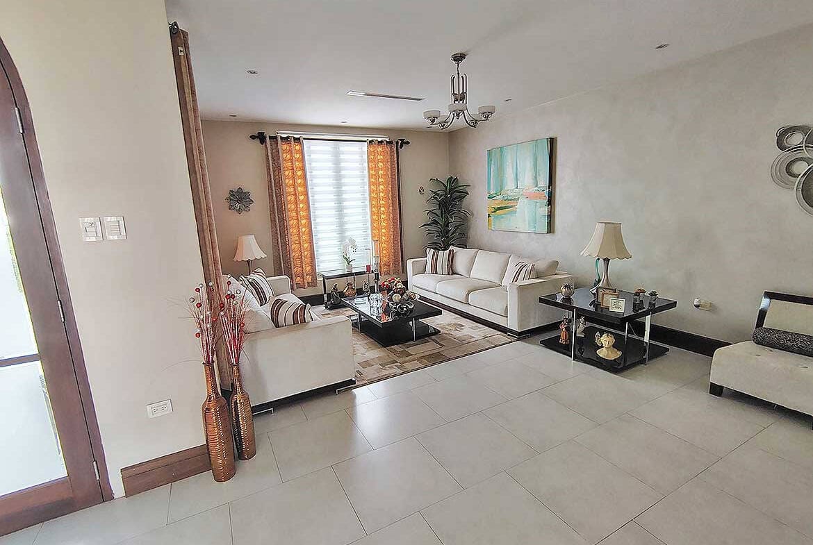 Cornerstone- Bright living room with modern furniture and decor at Millennium Lakes Home.