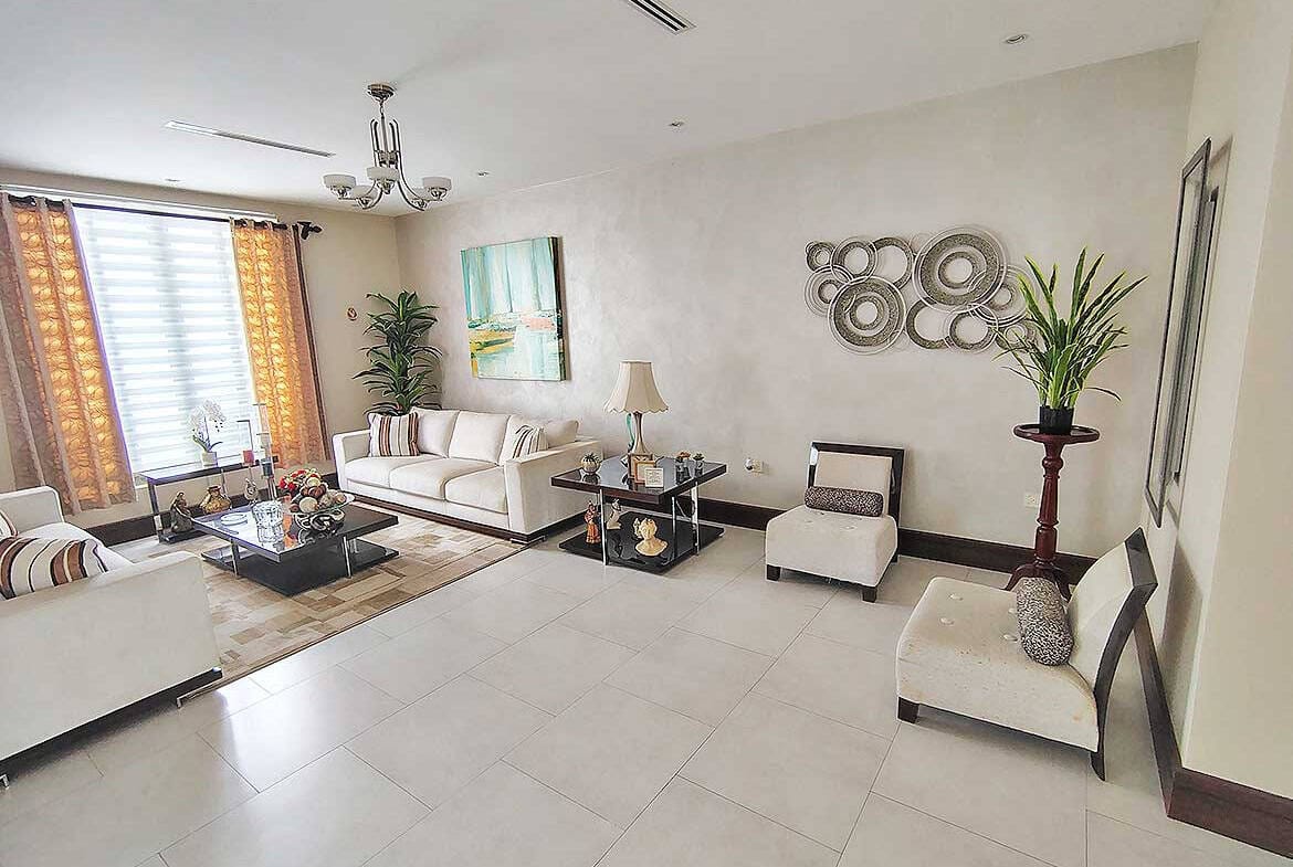 Cornerstone- Spacious living room with modern decor and natural light.