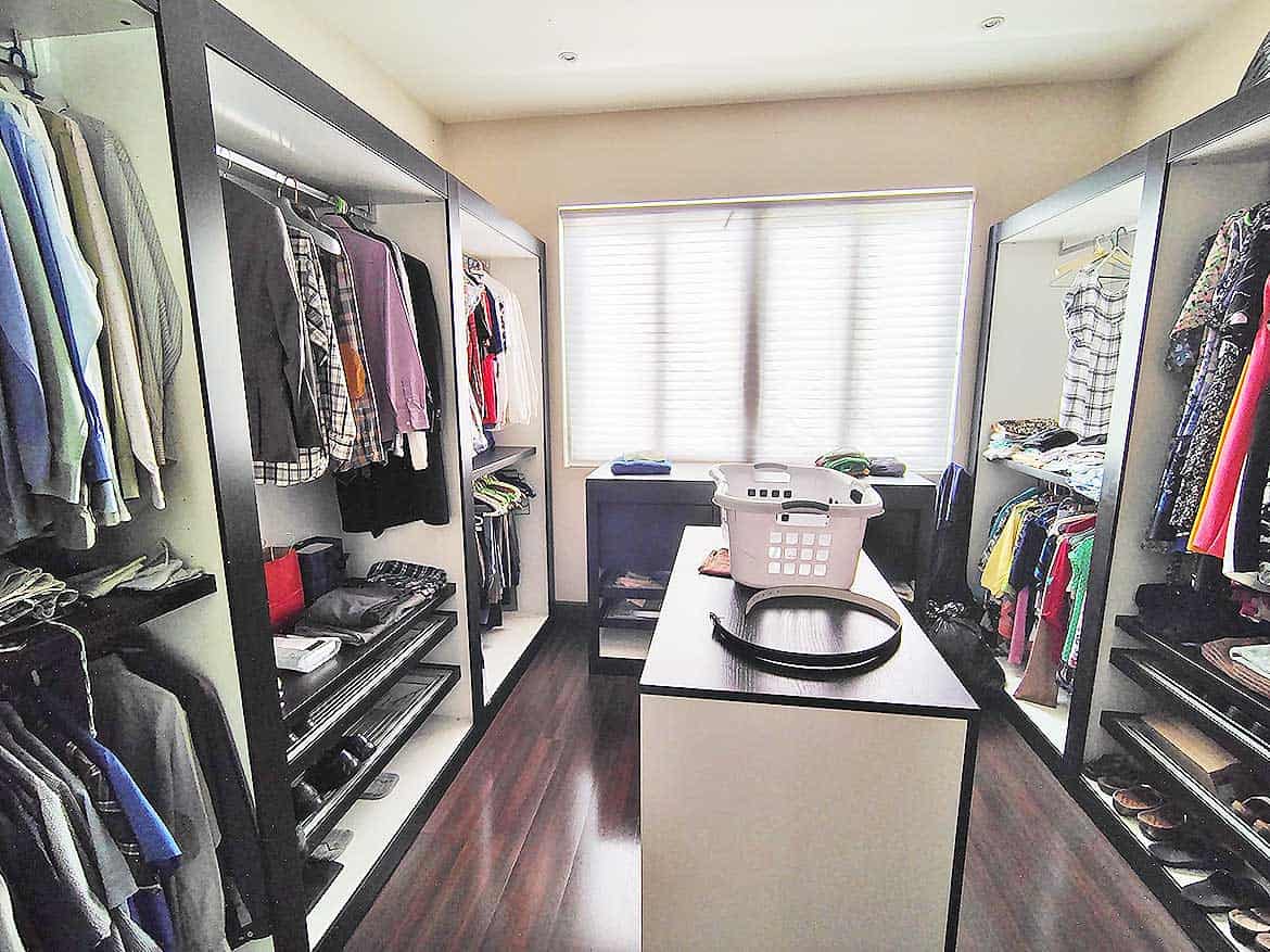 Cornerstone™ Walk-in Closet Cornerstone- Spacious walk-in closet with organized clothing and accessories.