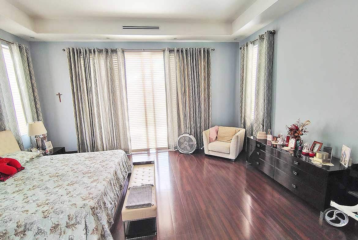 Cornerstone- Spacious living room with large windows, hardwood floors, and modern furniture.