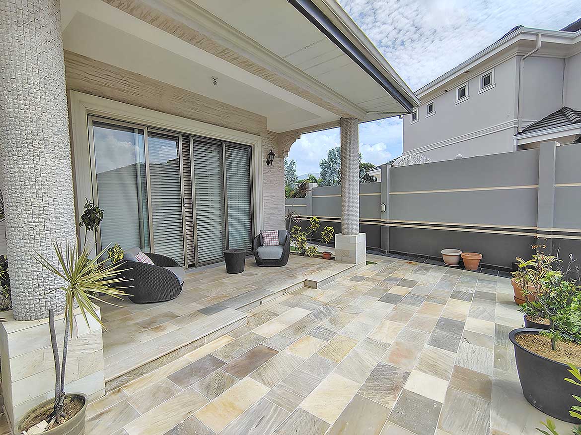 Cornerstone™ Millennium Lakes Home Patio Cornerstone- Spacious outdoor patio at Millennium Lakes Home with seating and potted plants.