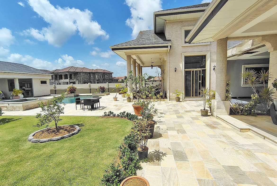 Cornerstone- Beautiful backyard with patio, garden, and pool at Millennium Lakes Home.