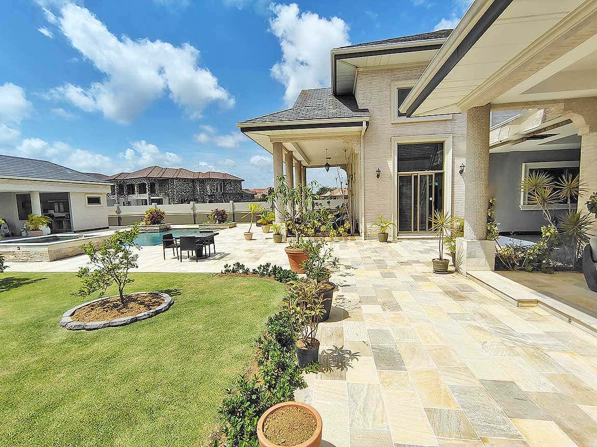 Luxury Home Exterior at Millennium Lakes Cornerstone- Beautiful backyard with patio, garden, and pool at Millennium Lakes Home.