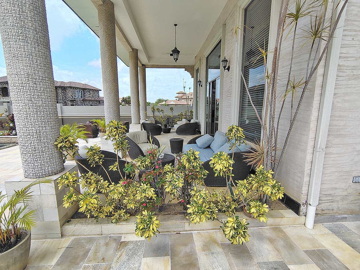 Cornerstone™ Millennium Lakes Home Porch Cornerstone- Elegant porch with outdoor seating and lush plants at Millennium Lakes Home.