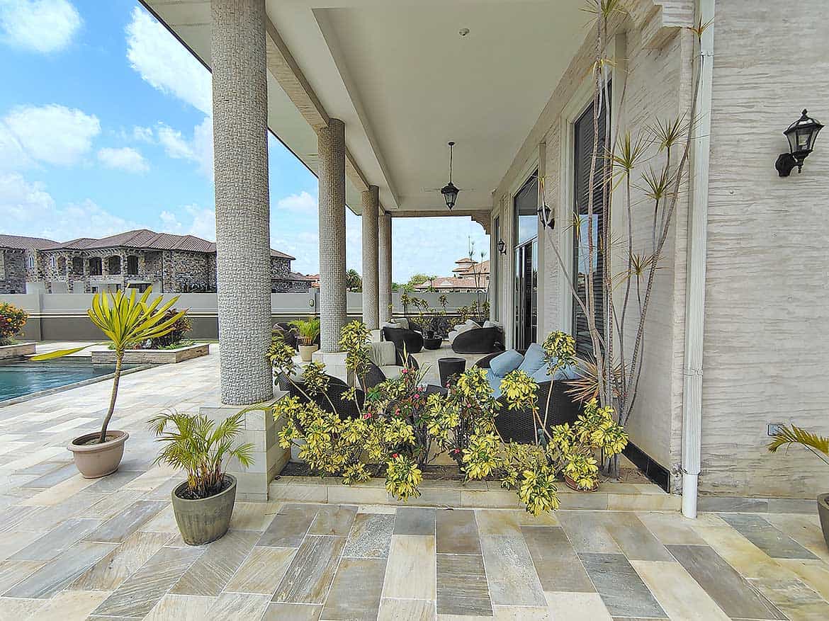 Cornerstone™ Millennium Lakes Home Porch Cornerstone- Elegant porch with potted plants and outdoor seating at Millennium Lakes Home.