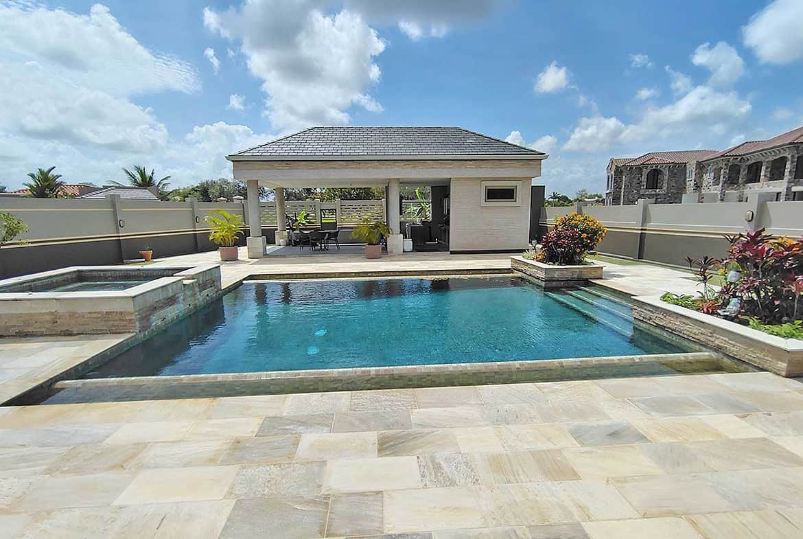 Cornerstone- Elegant backyard pool with pool house at Millennium Lakes Home.