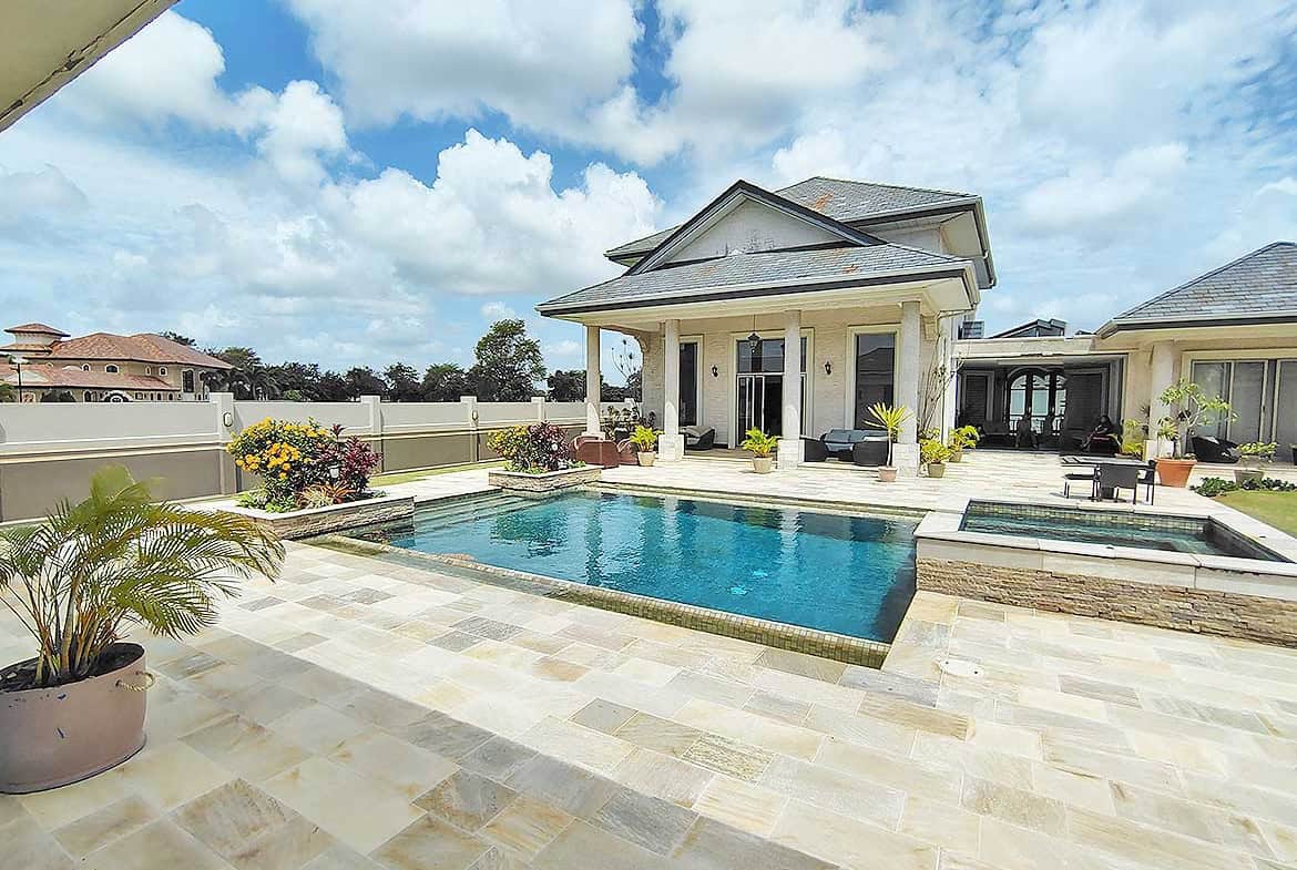 Cornerstone- Elegant backyard with swimming pool and patio at Millennium Lakes Home.