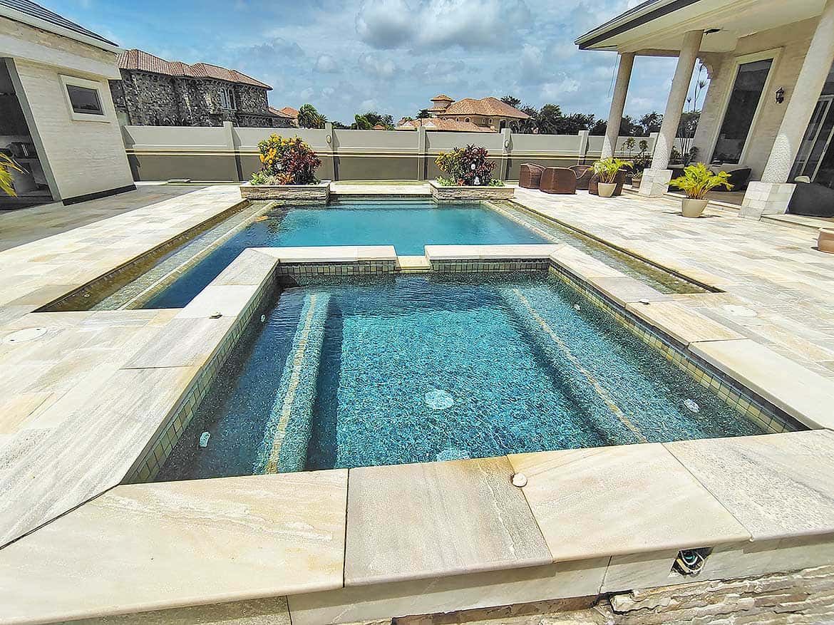 Luxury backyard pool with hot tub Cornerstone- Modern backyard pool with hot tub and spacious patio area.