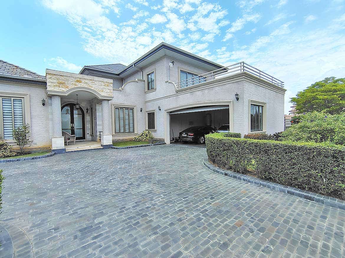 Luxury Modern Home at Millennium Lakes Cornerstone- Elegant modern house with spacious driveway and lush landscaping.