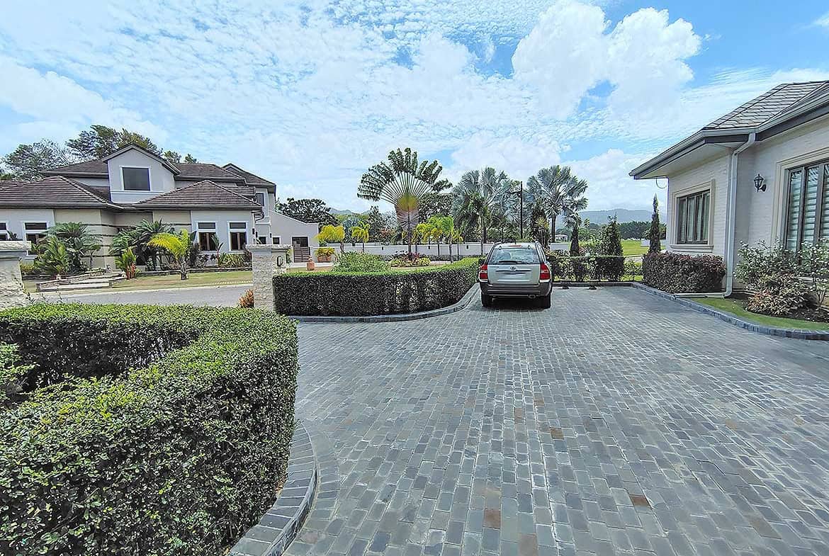 Cornerstone- Spacious driveway with parked car at Millennium Lakes Home.