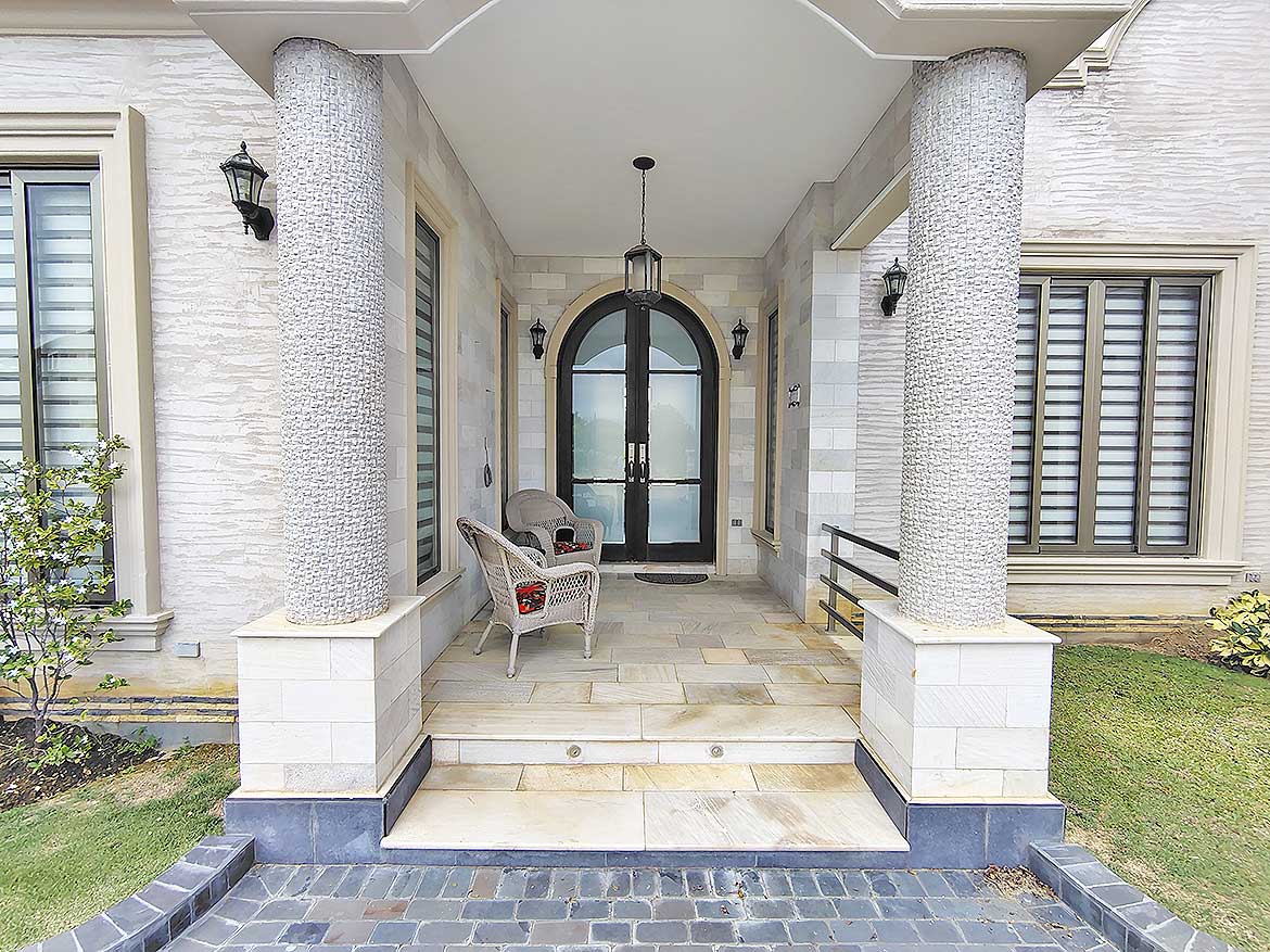 Millennium Lakes Home Entrance Cornerstone- Elegant home entrance with columns and seating area at Millennium Lakes.