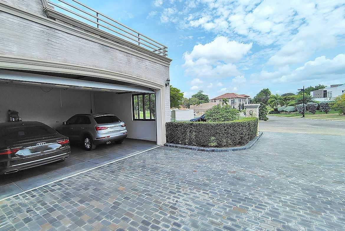 Cornerstone- Spacious parking area at Millennium Lakes Home with cars and paved driveway.