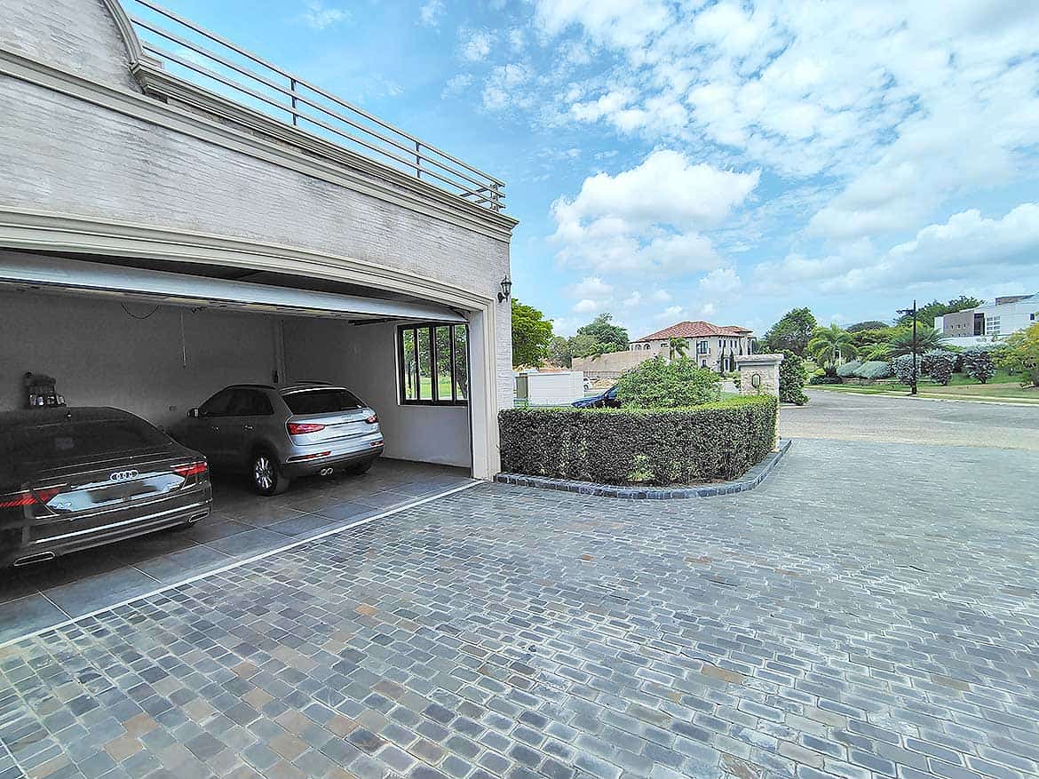 Millennium Lakes Home Parking Area Cornerstone- Spacious parking area at Millennium Lakes Home with cars and paved driveway.
